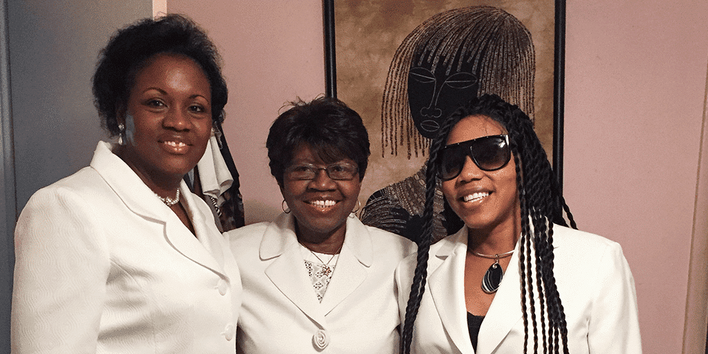 Sulie smiles for the camera with her loving daughters