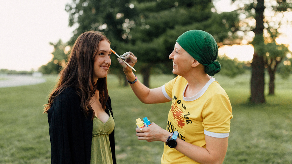 Natalie painting another woman's face 